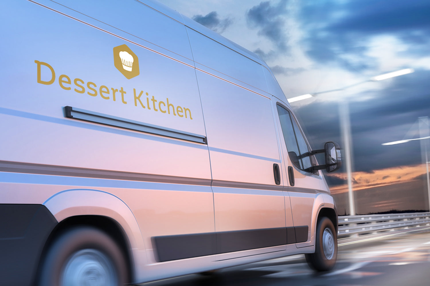Van with 'Dessert Kitchen' logo on a road with a blue sky background