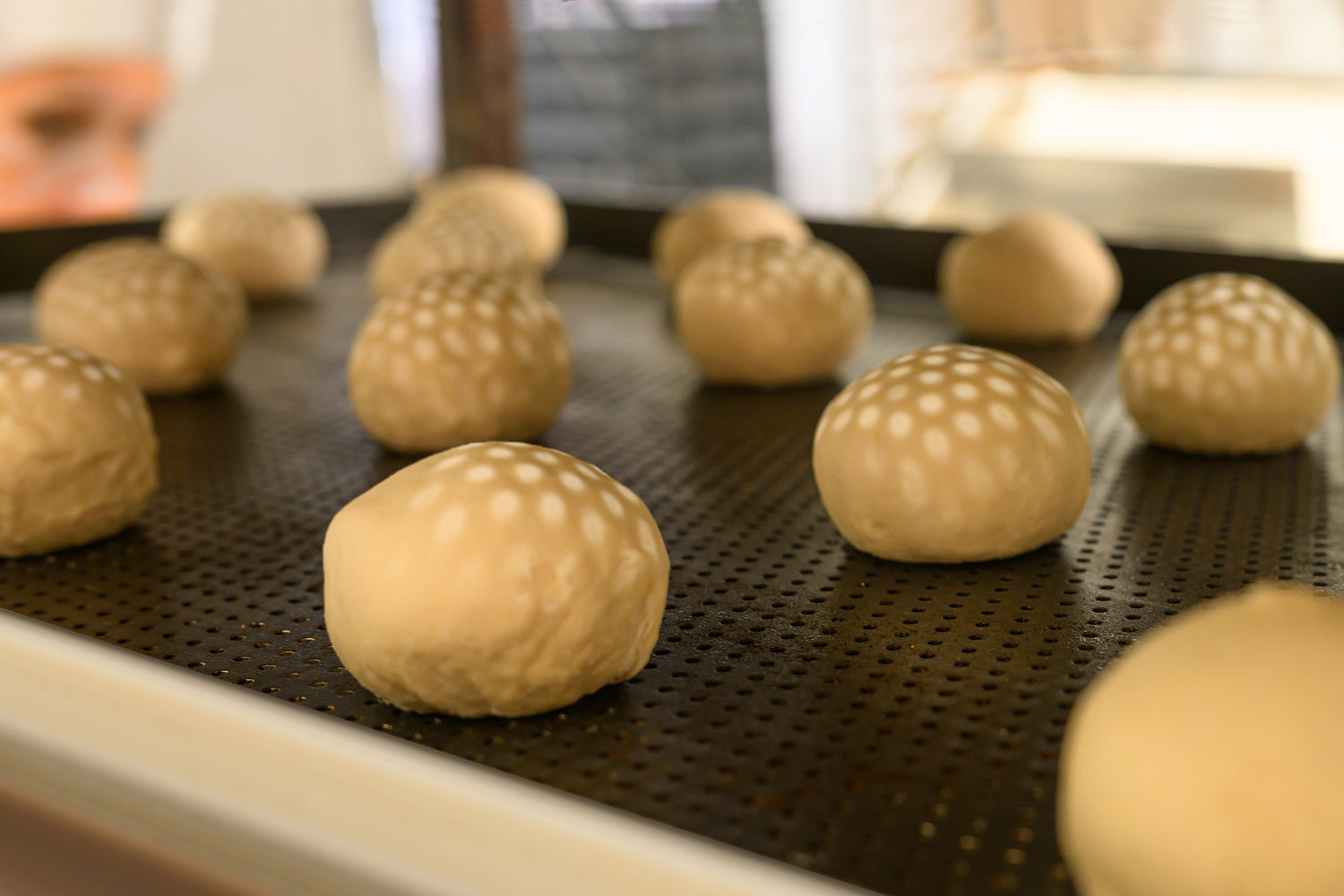 Baked goods with a textured surface on a baking tray. Dessert Kitchen Baked Good Partnerships