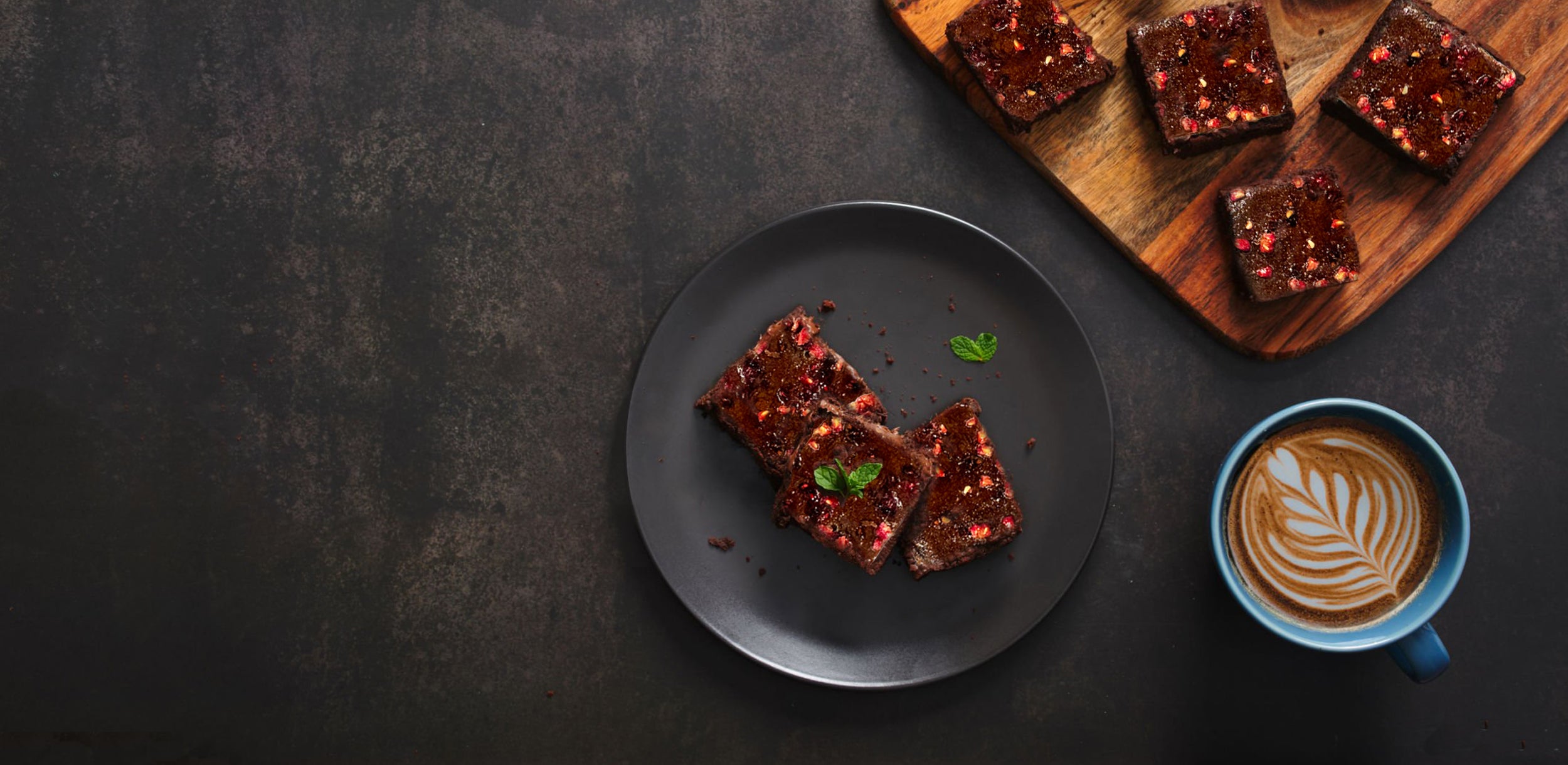 Dessert bars on a plate with a cup of coffee on a dark surface. Dessert Kitchen Desserts