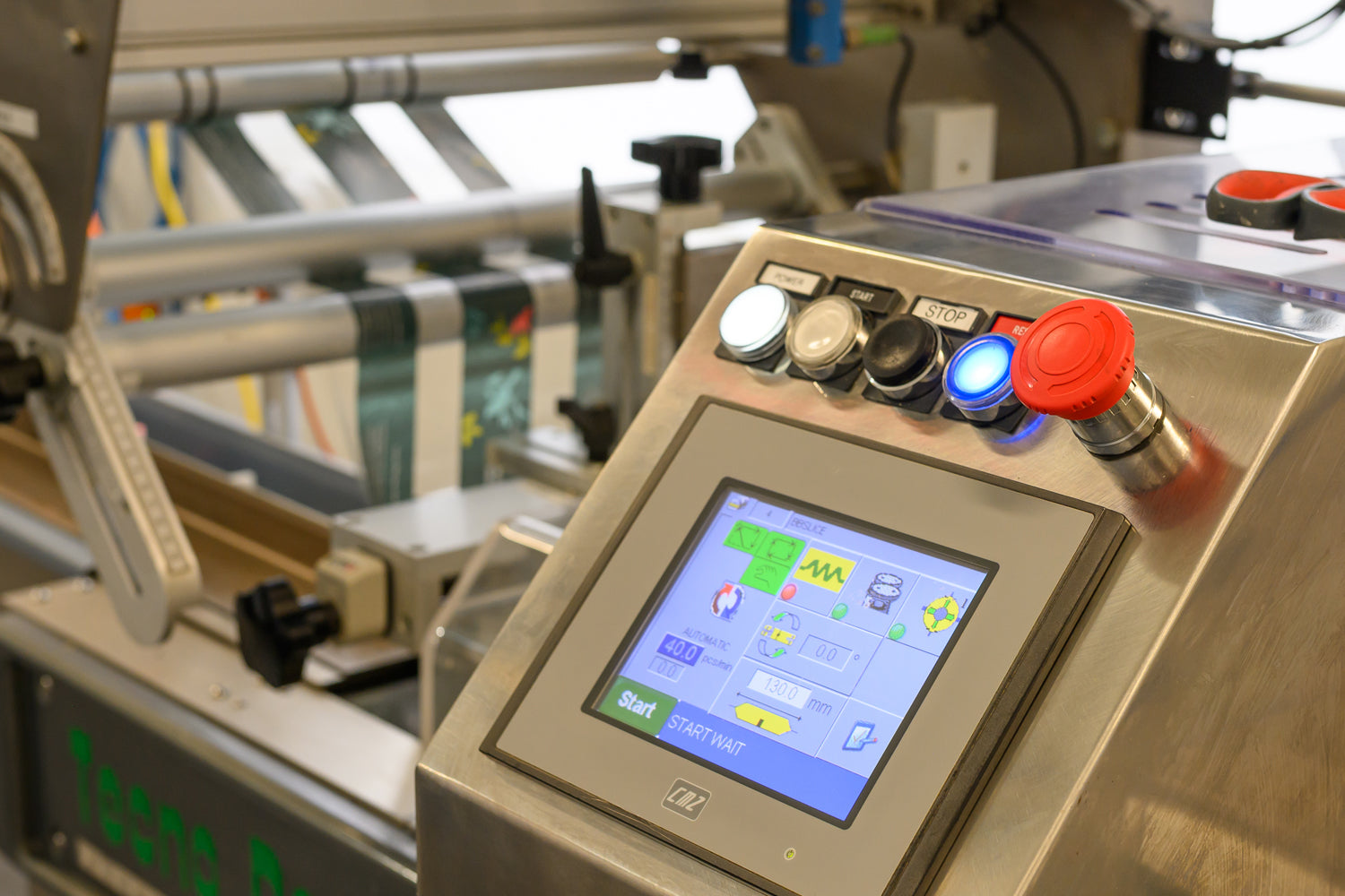 Control panel with touchscreen display on a machine in Dessert Kitchen's commercial kitchen setting