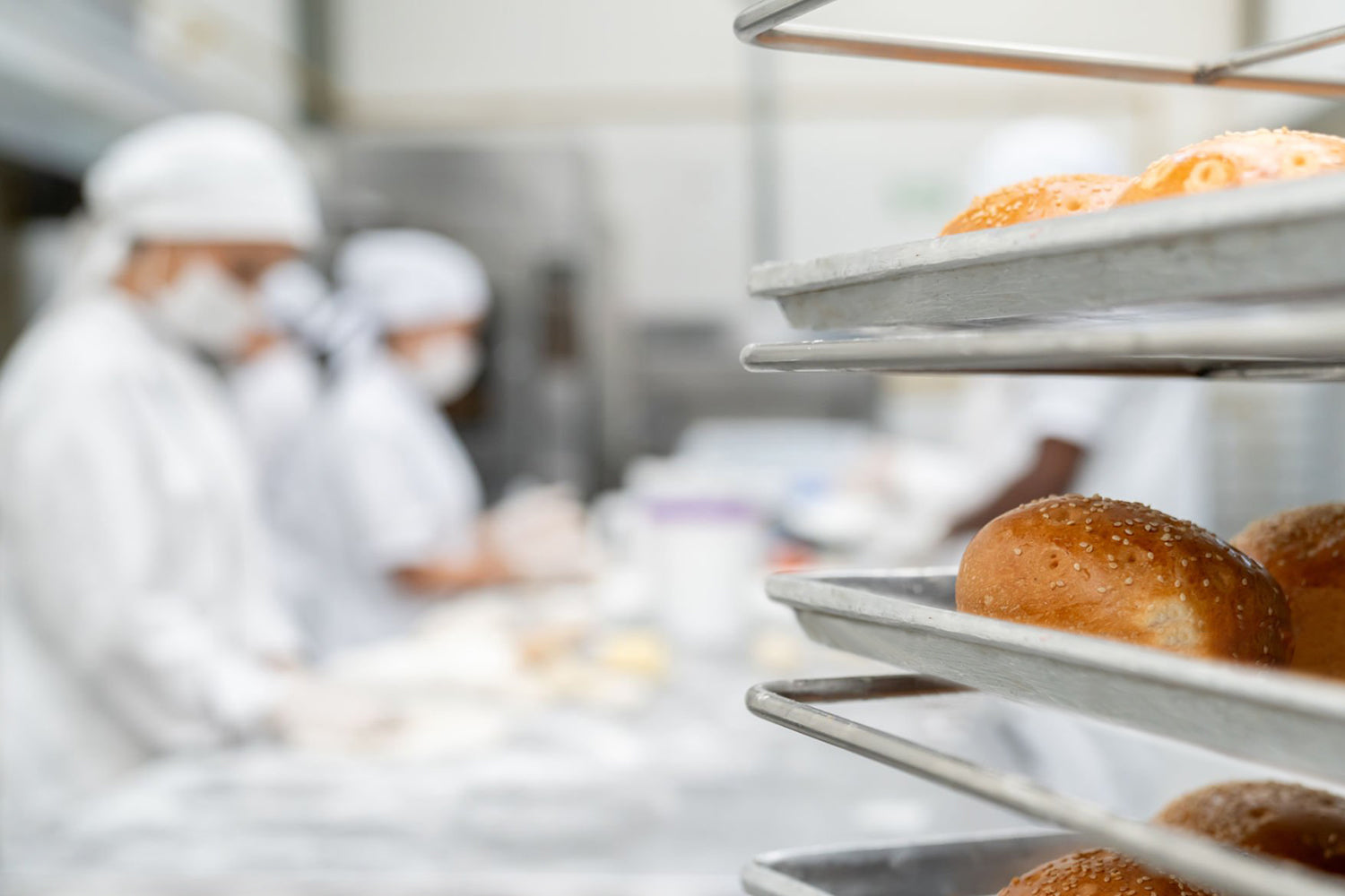 Baked goods on trays with blurred background of a bakery kitchen. Dessert Kitchen