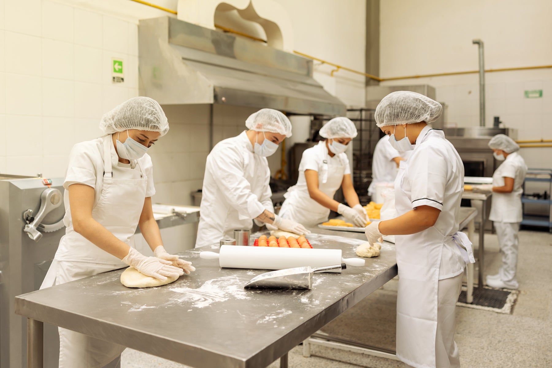 Group of chefs working in a professional commercial kitchen. Dessert Kitchen About Us