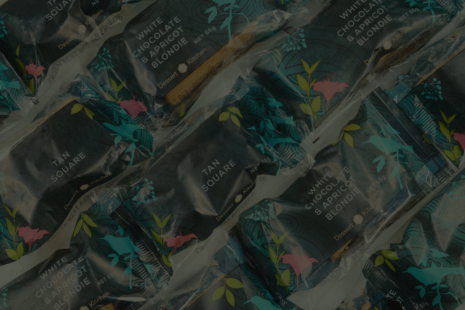Multiple packages of Tan Square chocolate bars with floral design on packaging. Dessert Kitchen Partnership Co Branding