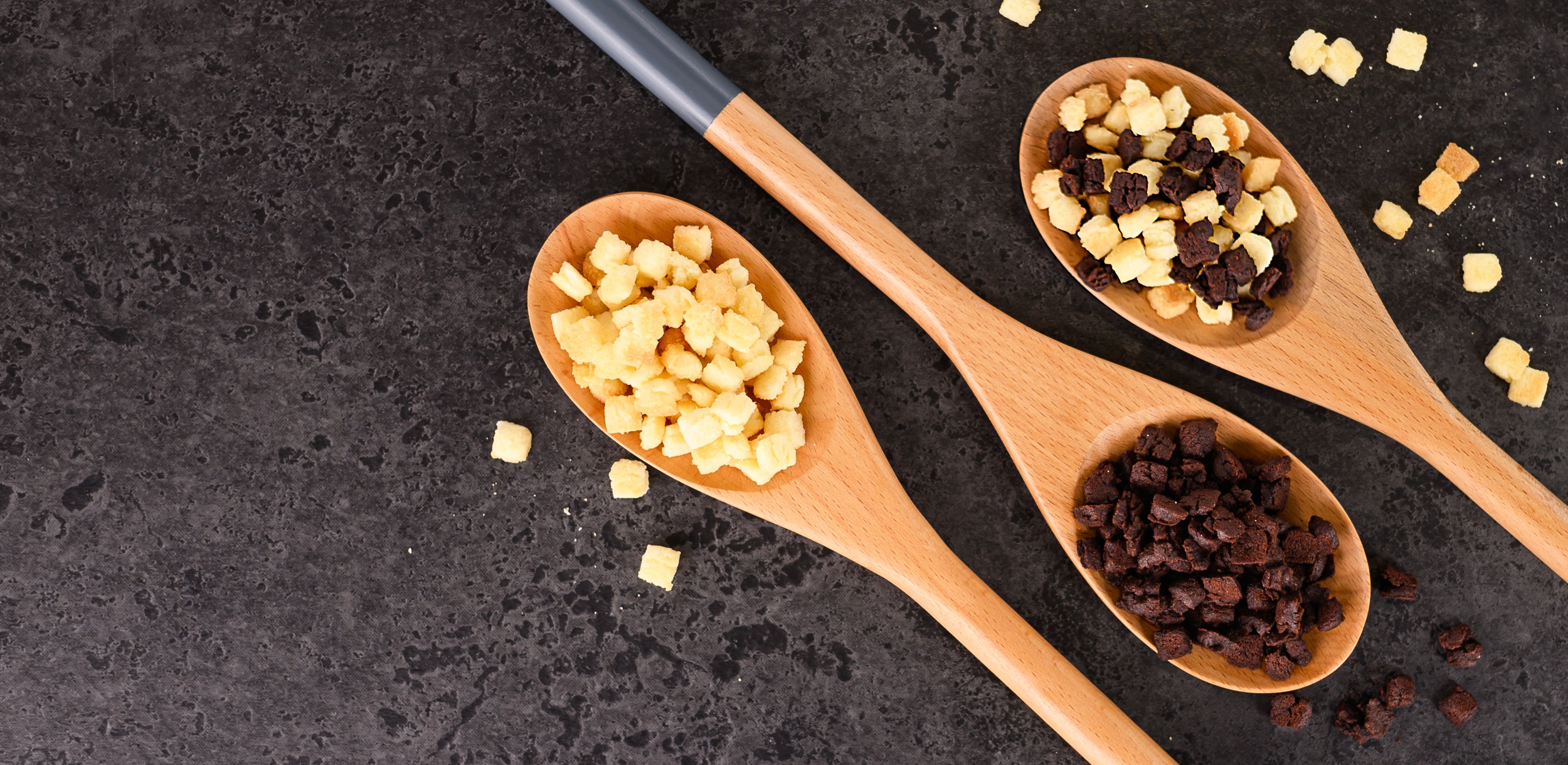 Wooden spoons with food inclusions on a dark surface Dessert Kitchen